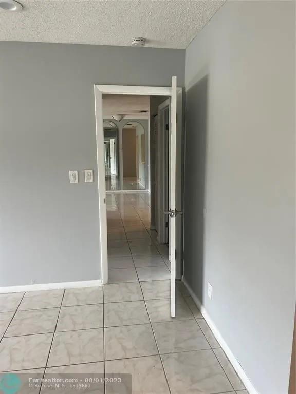 4131 Northwest 88th Avenue, Unit 206 Coral Springs, FL 33065 - Photo 13 of 41 a view of livingroom with an empty space and window