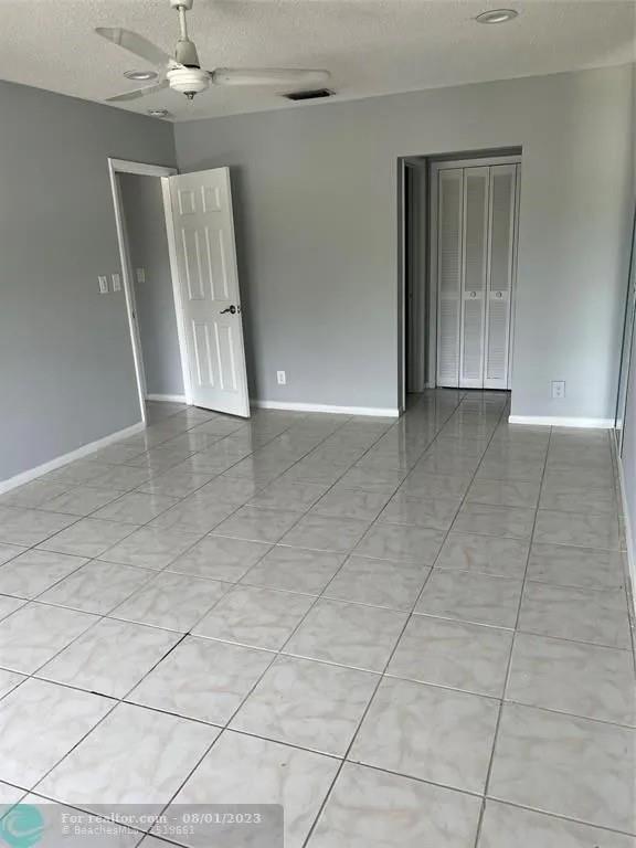 4131 Northwest 88th Avenue, Unit 206 Coral Springs, FL 33065 - Photo 14 of 41 a view of an empty room with a window