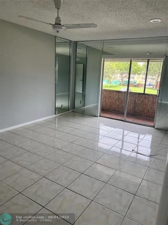 4131 Northwest 88th Avenue, Unit 206 Coral Springs, FL 33065 - Photo 15 of 41 en empty room with sliding door and mountain view