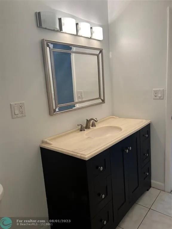 4131 Northwest 88th Avenue, Unit 206 Coral Springs, FL 33065 - Photo 25 of 41 a bathroom with a sink vanity and a mirror