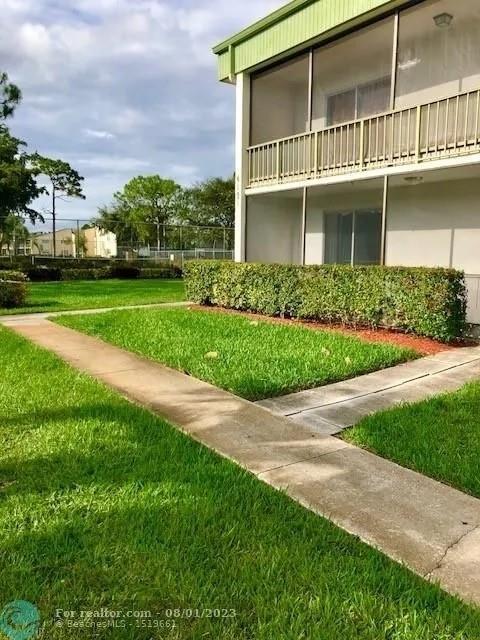 4131 Northwest 88th Avenue, Unit 206 Coral Springs, FL 33065 - Photo 30 of 41 front view of a house with a yard