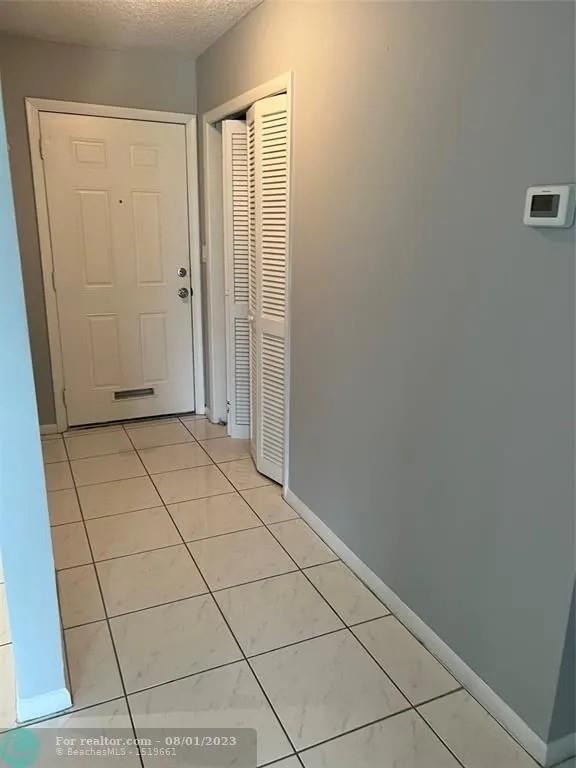 4131 Northwest 88th Avenue, Unit 206 Coral Springs, FL 33065 - Photo 8 of 41 a view of a livingroom with an empty space and a window