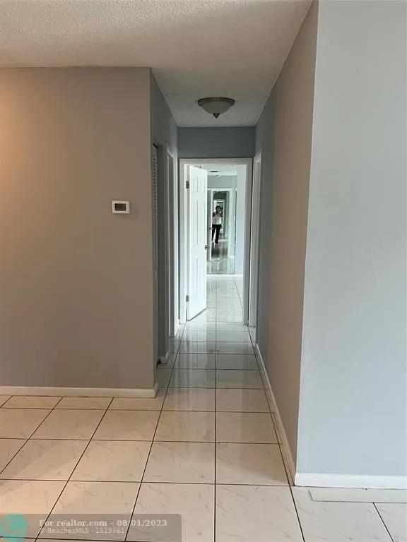 4131 Northwest 88th Avenue, Unit 206 Coral Springs, FL 33065 - Photo 10 of 41 a view of hallway with a window and a refrigerator