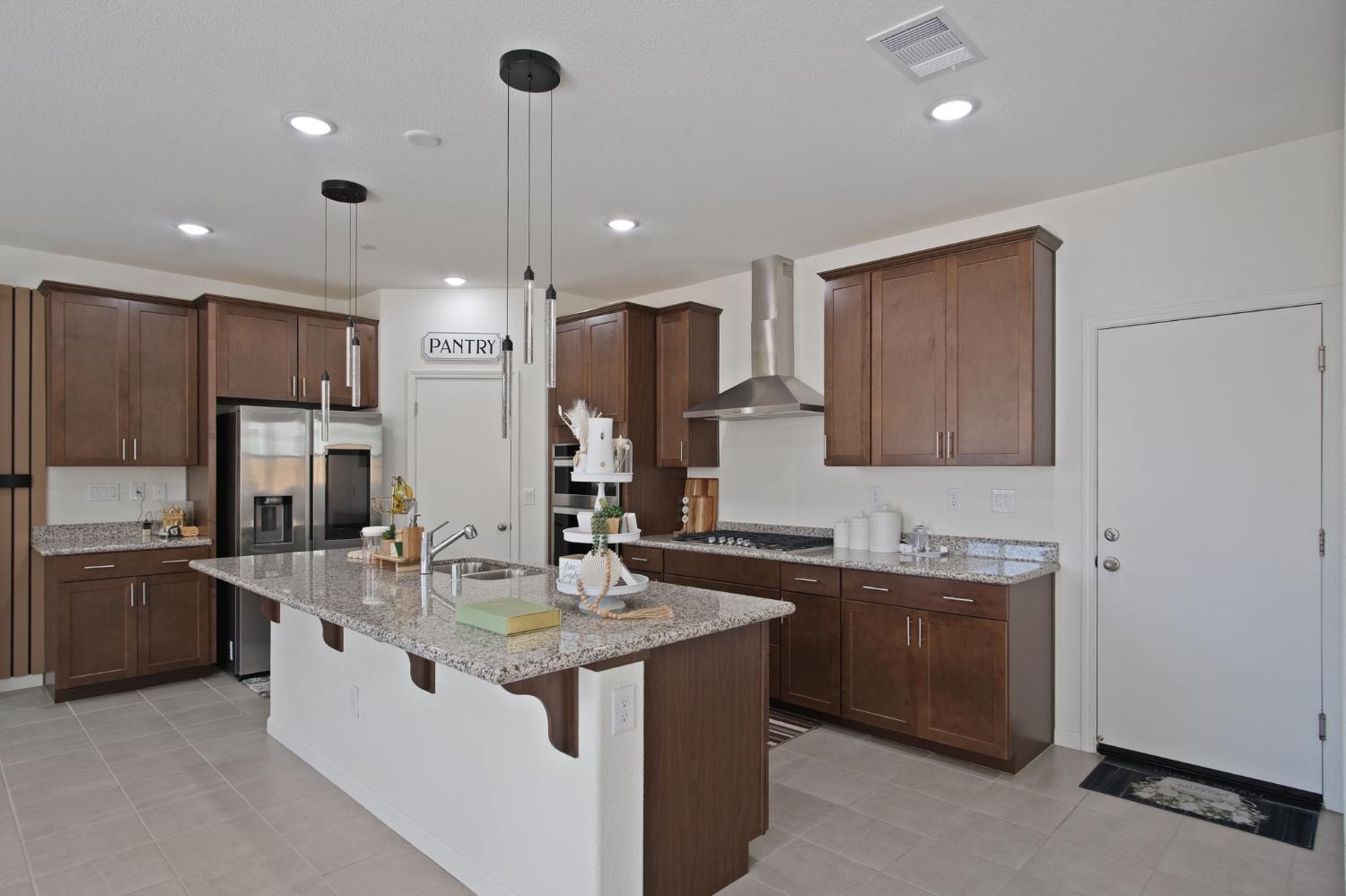 1432 Meridian Street Manteca, CA 95337 - Photo 12 of 42 a kitchen with stainless steel appliances granite countertop a sink a stove and a refrigerator