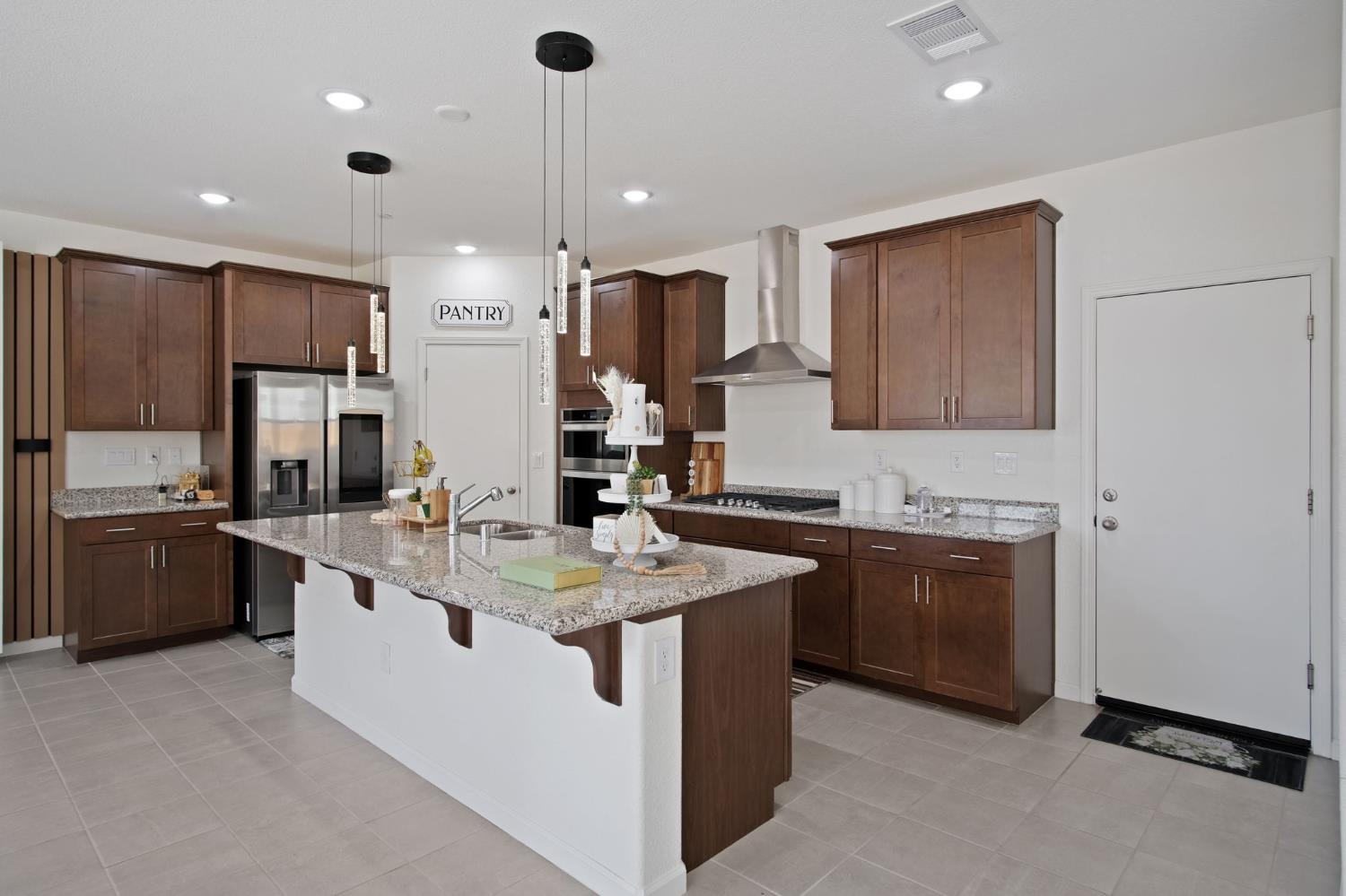 1432 Meridian Street Manteca, CA 95337 - Photo 15 of 42 a kitchen with stainless steel appliances granite countertop a sink a stove and a refrigerator
