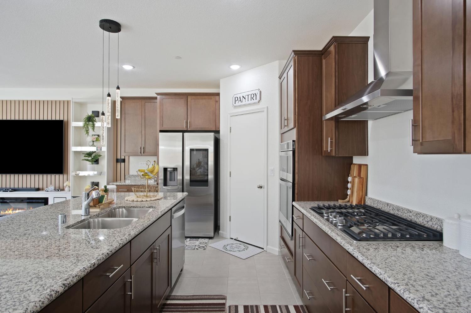 1432 Meridian Street Manteca, CA 95337 - Photo 16 of 42 a kitchen with stainless steel appliances granite countertop a sink stove and refrigerator