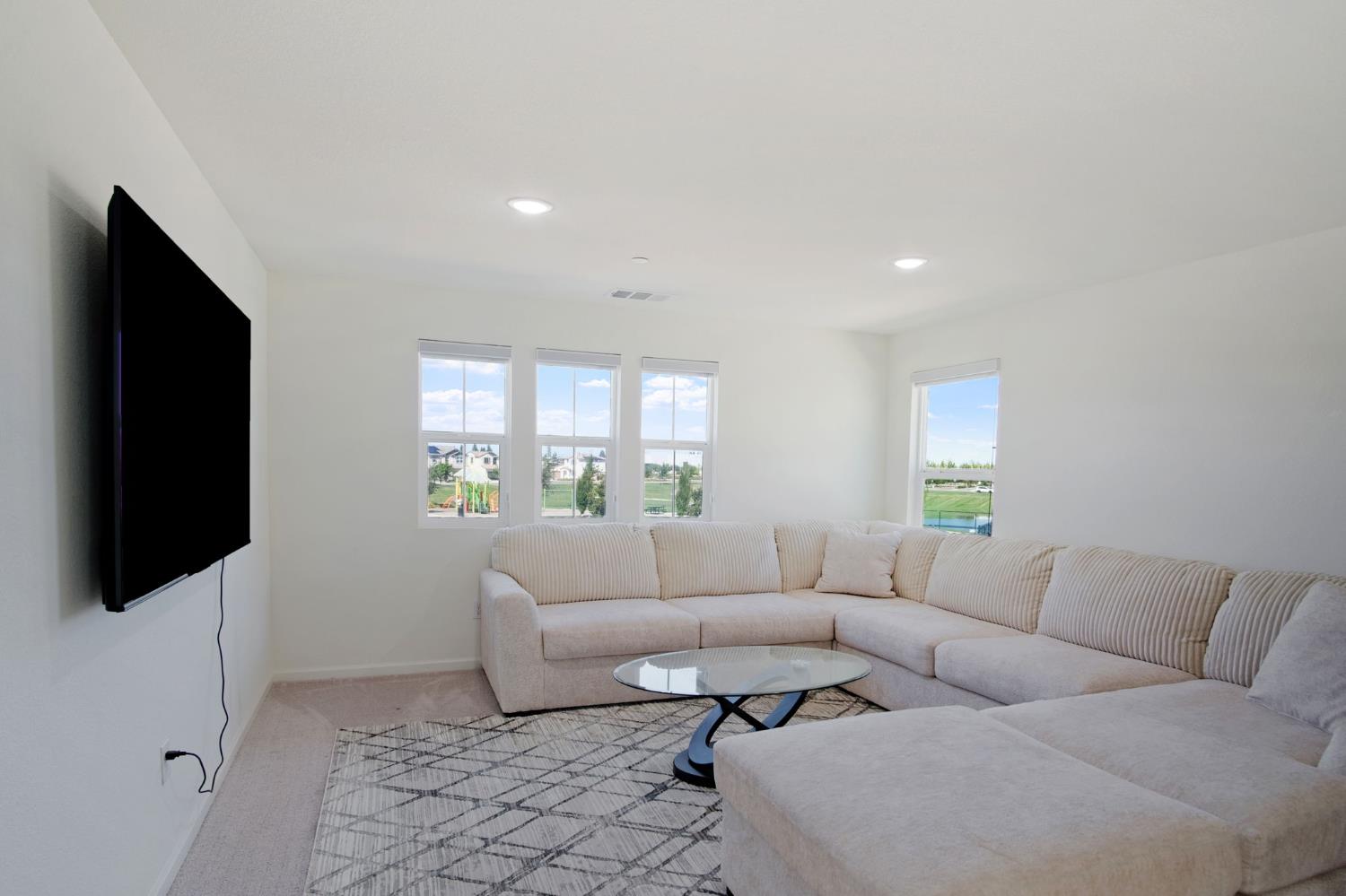 1432 Meridian Street Manteca, CA 95337 - Photo 18 of 42 a living room with furniture and a flat screen tv
