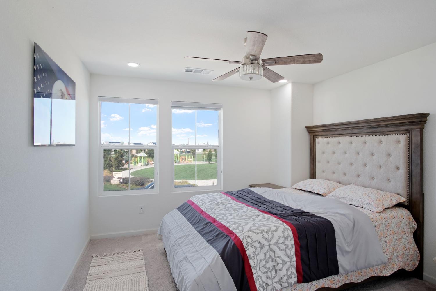 1432 Meridian Street Manteca, CA 95337 - Photo 20 of 42 a bedroom with a large bed and a window