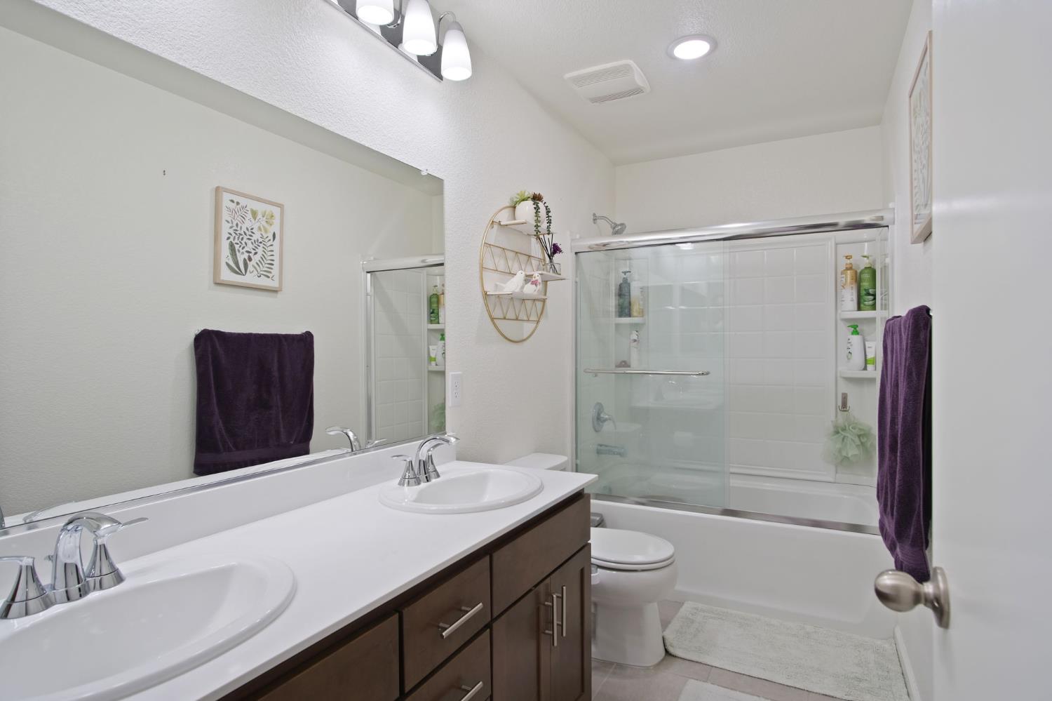 1432 Meridian Street Manteca, CA 95337 - Photo 22 of 42 a bathroom with a granite countertop sink toilet and shower