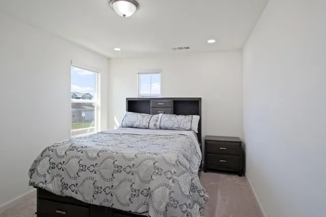 a bedroom with a bed and window