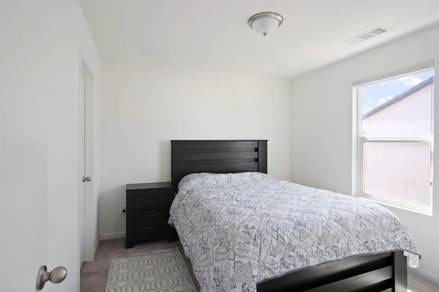 a bedroom with a bed and a window