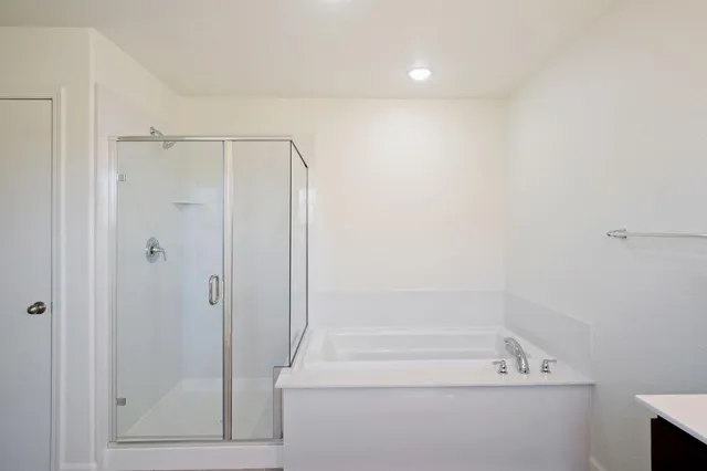 a bathroom with a shower and a tub