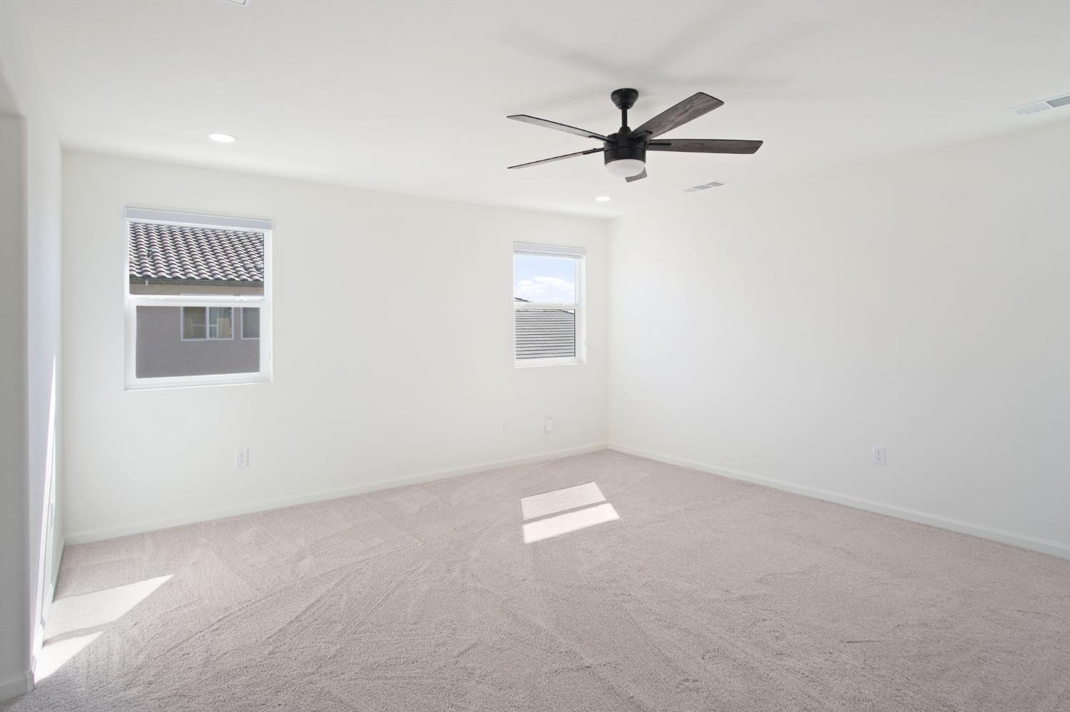 1432 Meridian Street Manteca, CA 95337 - Photo 30 of 42 an empty room with windows and fan