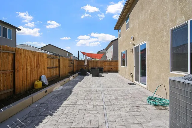 a view of a street with wooden fence