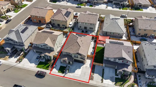 an aerial view of residential houses with street