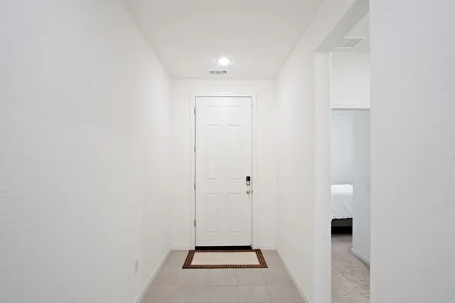 a view of a hallway with wooden floor and closet
