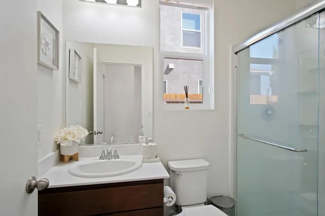 a bathroom with a sink toilet and mirror