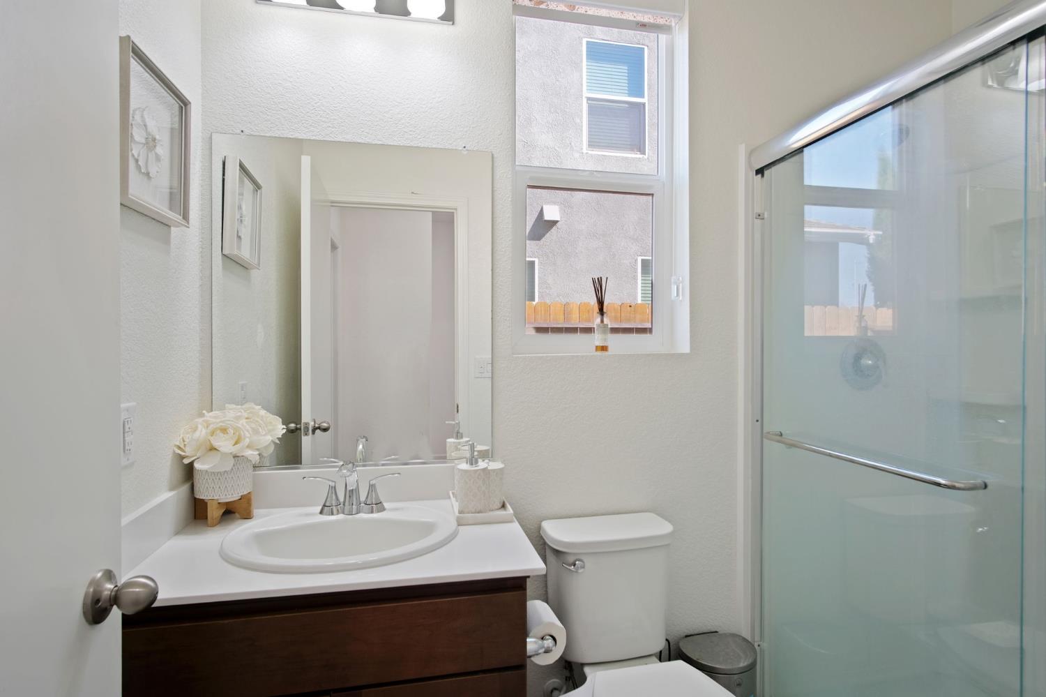 1432 Meridian Street Manteca, CA 95337 - Photo 6 of 42 a bathroom with a sink toilet and mirror