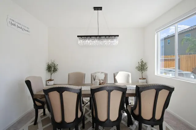 a view of a dining room with furniture window and outside view
