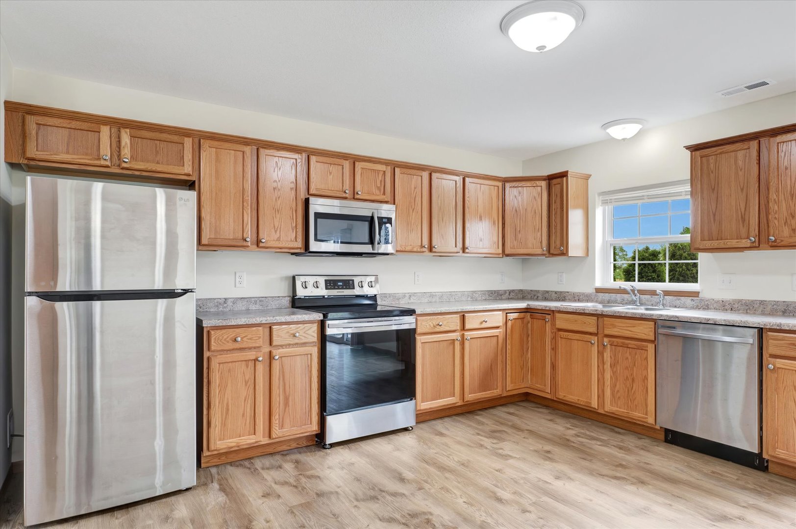 3315 Boulder Ridge Drive Champaign, IL 61822 - Photo 3 of 8 a kitchen with stainless steel appliances granite countertop a refrigerator stove microwave and sink