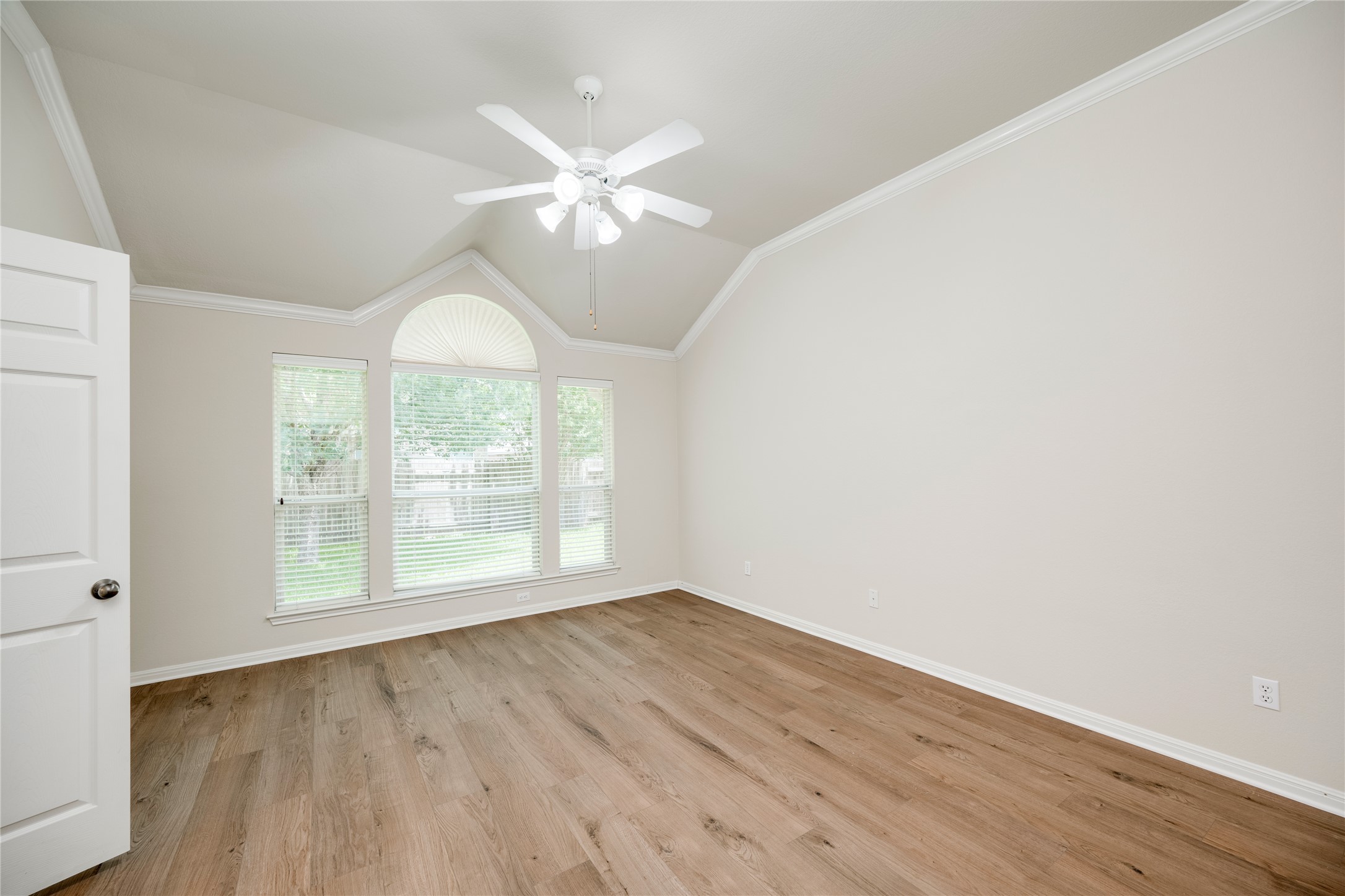 1813 Nelson Ranch Loop Cedar Park, TX 78613 - Photo 17 of 39 A well-lit room featuring warm wood flooring, high vaulted ceilings, and a series of windows that bring in ample natural light.
