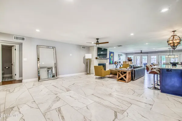 a kitchen with stainless steel appliances granite countertop a refrigerator and a counter top space