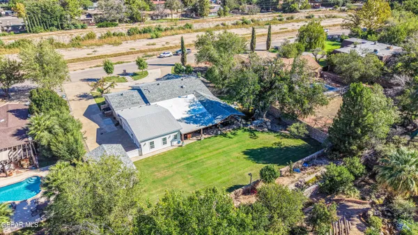 an aerial view of a house with a yard basket ball court and outdoor seating