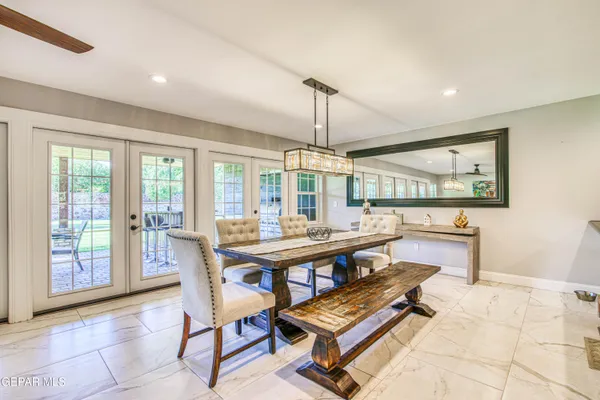 a bedroom with a bed and a large mirror with a desk