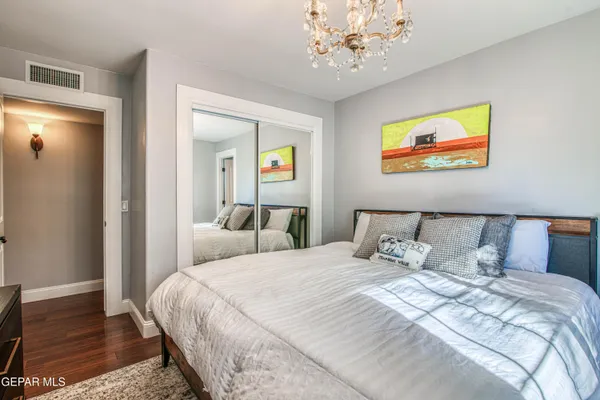 a view of swimming pool with lawn chairs and plants