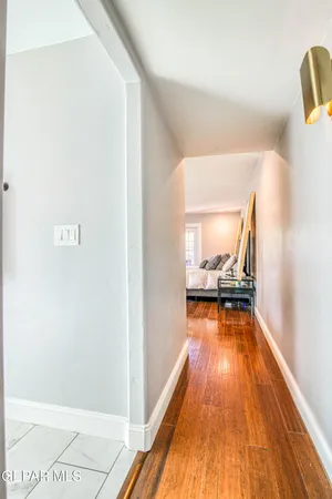 a front view of a house with a garden and trees