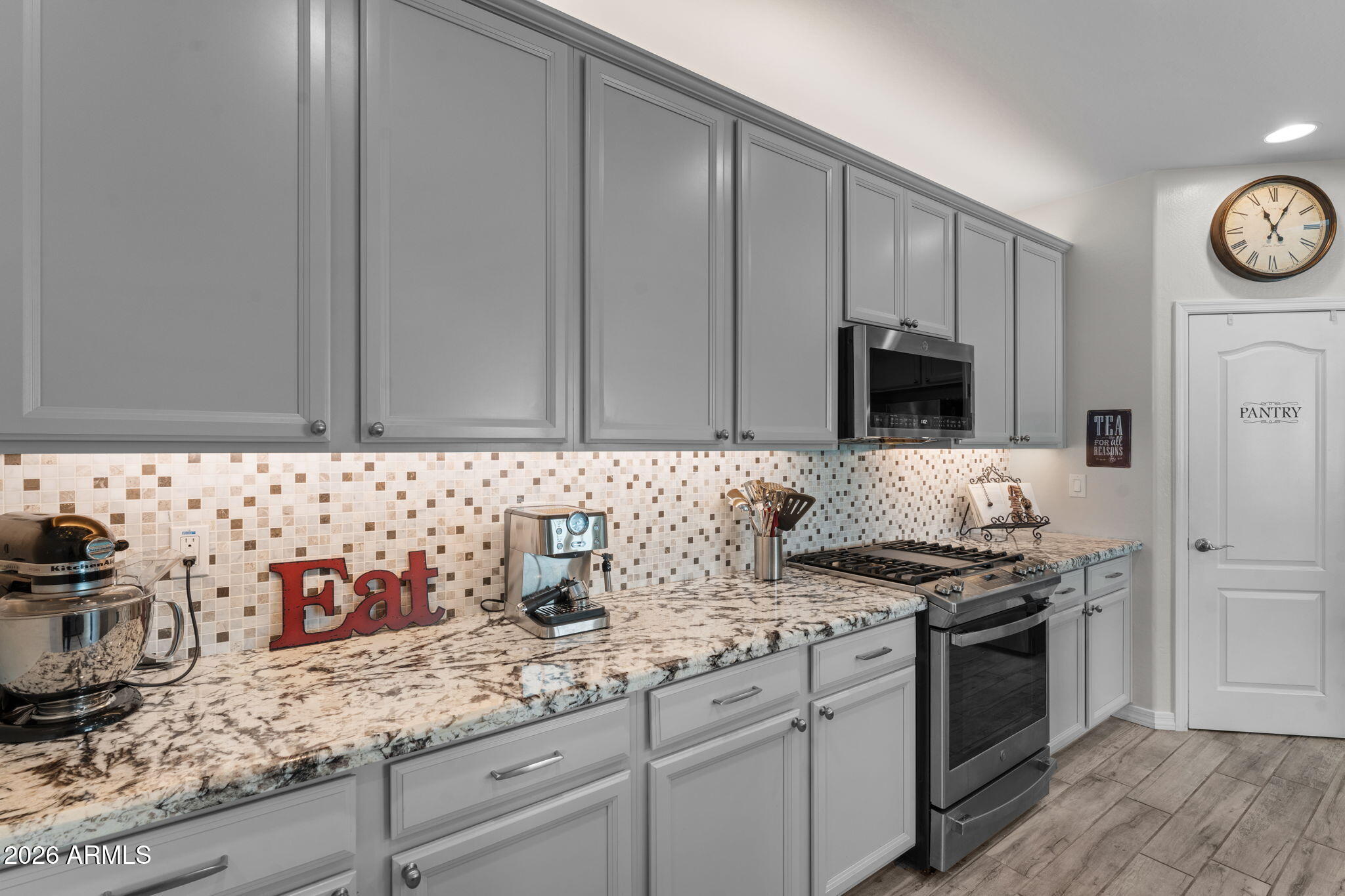 4320 Buffalo Ridge Wickenburg, AZ 85390 - Photo 11 of 57 a kitchen with stainless steel appliances granite countertop a sink stove top oven and cabinets
