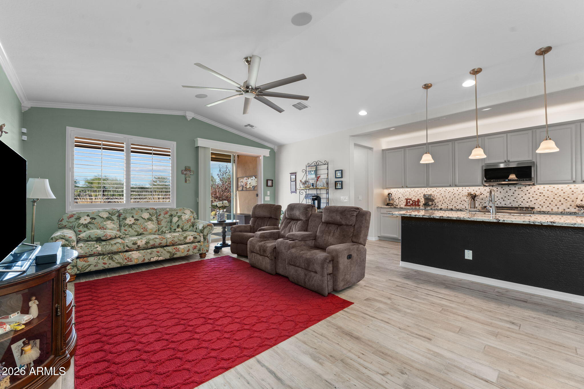 4320 Buffalo Ridge Wickenburg, AZ 85390 - Photo 17 of 57 a living room with a couch wooden floor and a large window