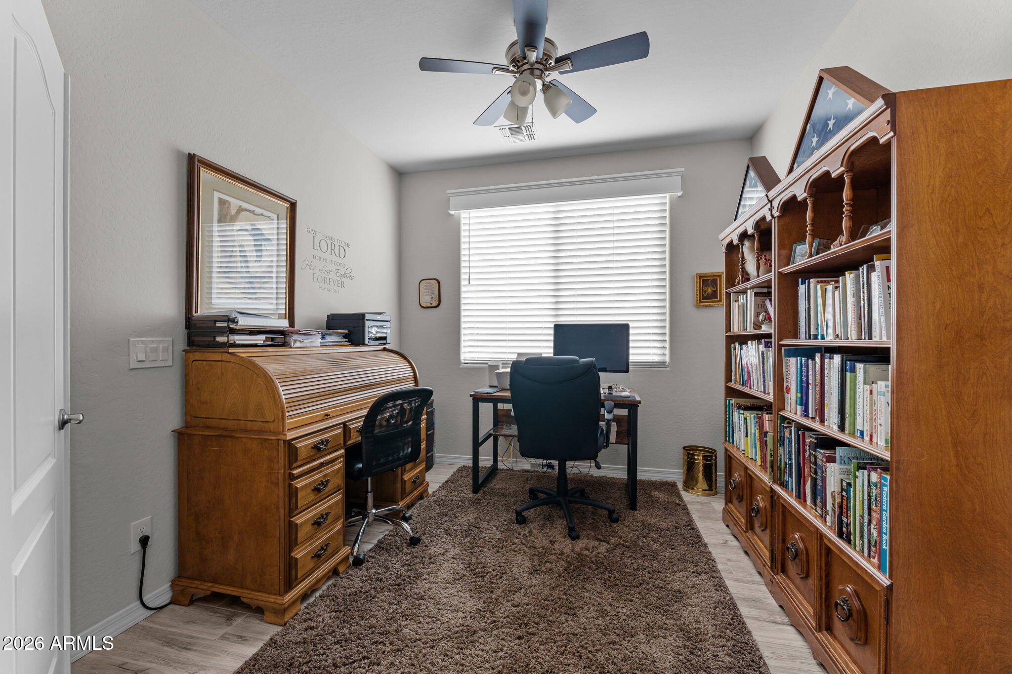 4320 Buffalo Ridge Wickenburg, AZ 85390 - Photo 20 of 57 a view of a workspace with furniture and a bookshelf