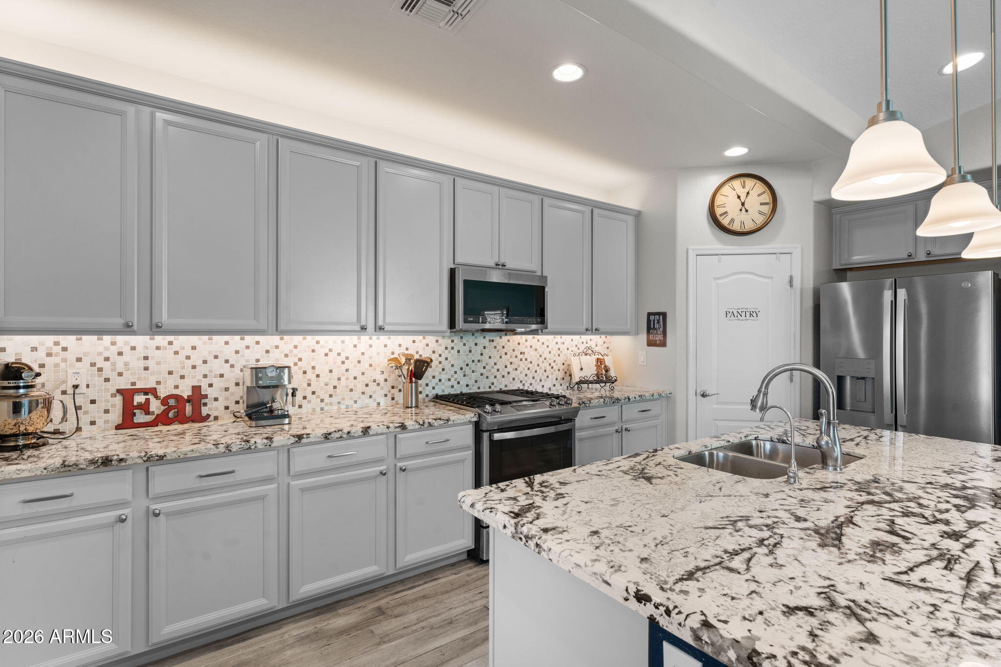 4320 Buffalo Ridge Wickenburg, AZ 85390 - Photo 6 of 57 a kitchen with cabinets a sink and stainless steel appliances