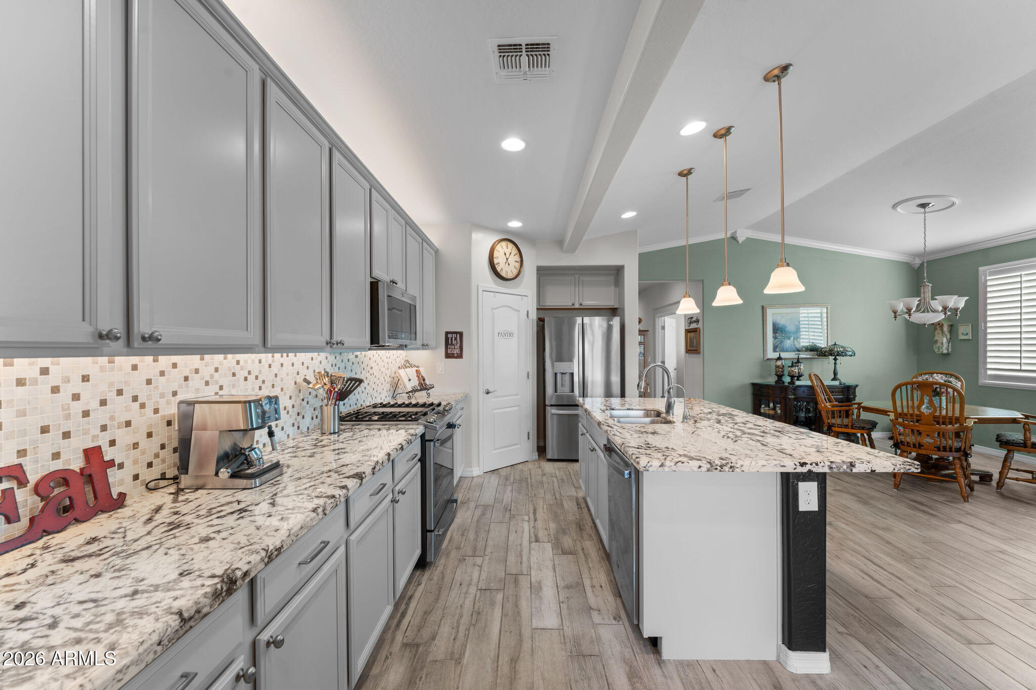 4320 Buffalo Ridge Wickenburg, AZ 85390 - Photo 8 of 57 a large kitchen with stainless steel appliances kitchen island granite countertop a sink a stove and a wooden floors