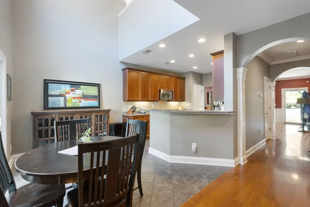 a kitchen with stainless steel appliances granite countertop wooden cabinets and a stove top oven