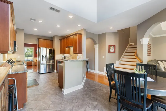 a kitchen with stainless steel appliances granite countertop wooden cabinets a sink and dishwasher