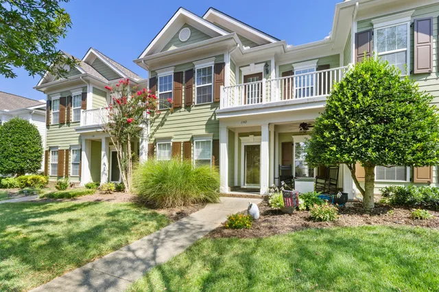 a living room with furniture floor to ceiling window and a flat screen tv