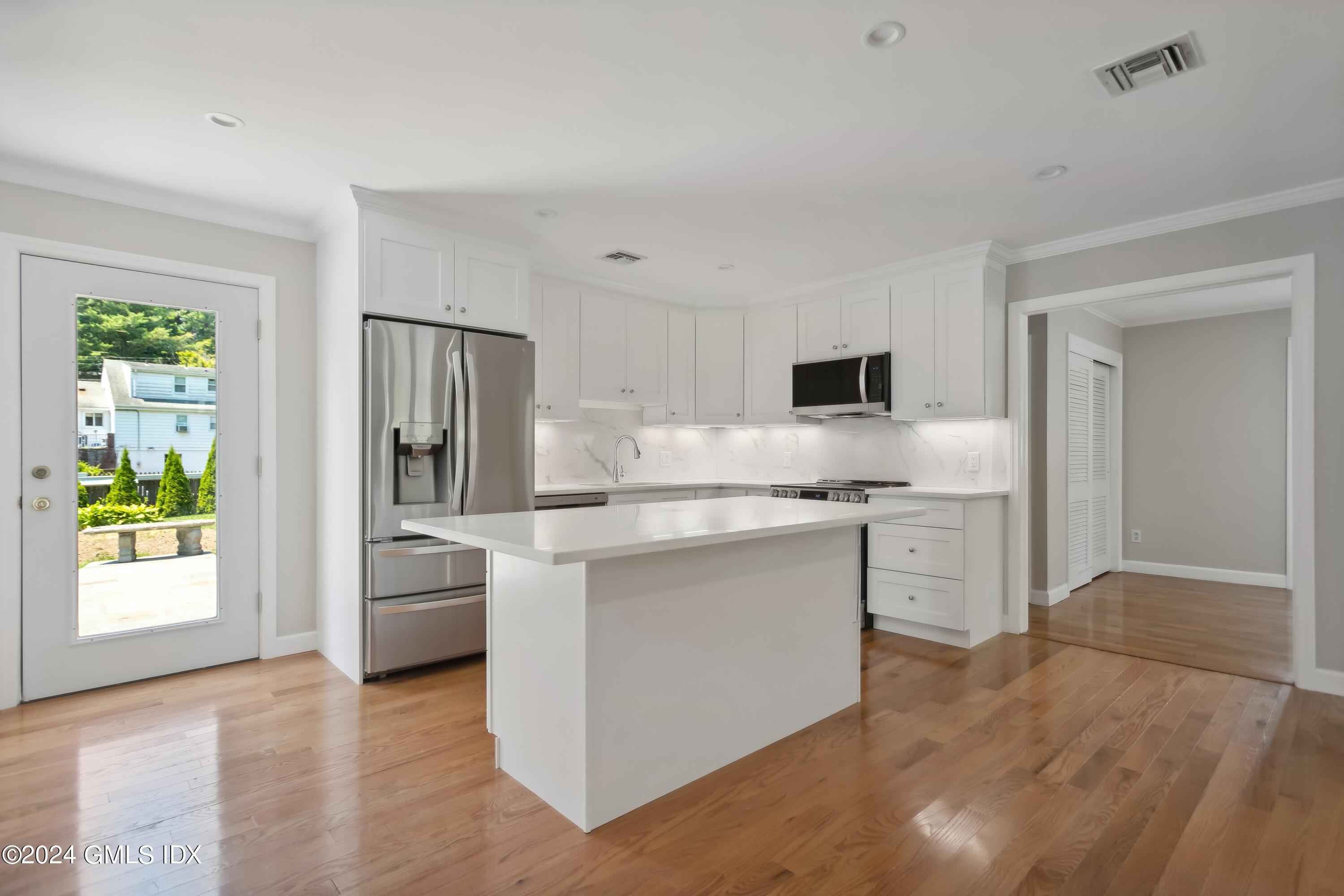 12 Wescott Street Riverside, CT 06878 - Photo 4 of 12 a kitchen with stainless steel appliances white cabinets and wooden floor
