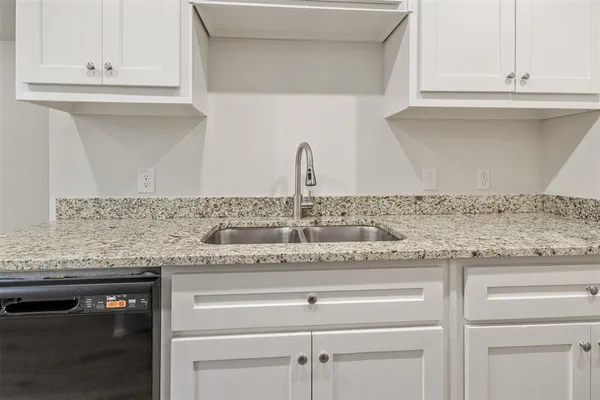a kitchen with granite countertop white cabinets and a granite counter tops