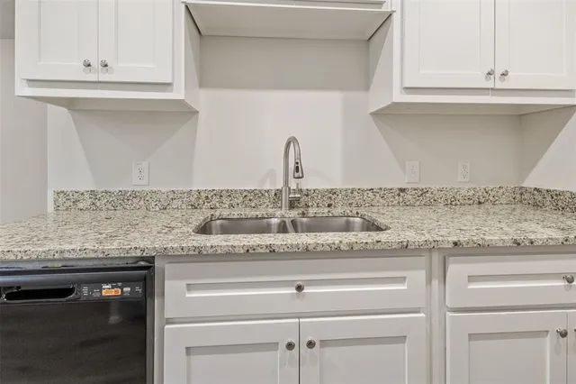 a kitchen with granite countertop white cabinets and a granite counter tops