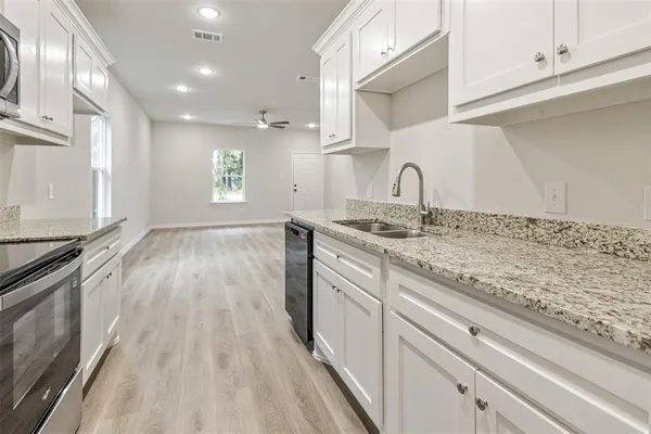 a view of a kitchen with sink and dishwasher