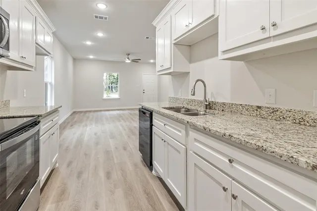 a view of a kitchen with sink and dishwasher