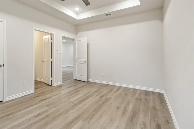 an empty room with wooden floor and closet
