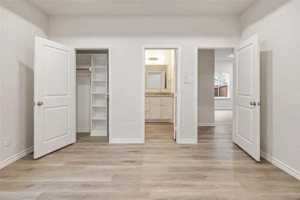 an empty room with closet and wooden floor