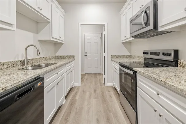 a kitchen with stainless steel appliances granite countertop a stove and a sink