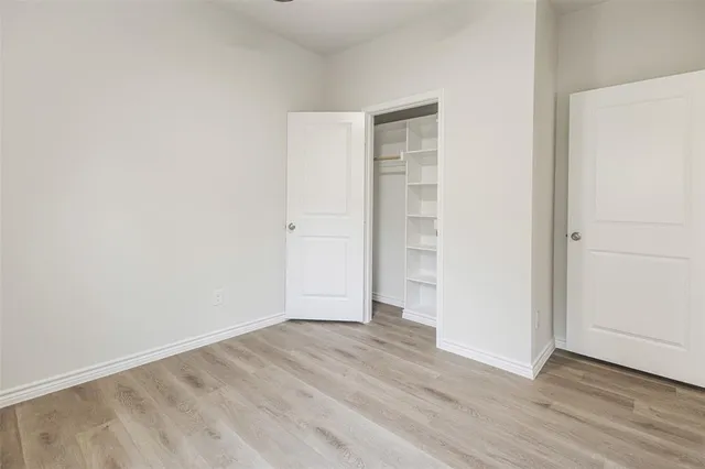 an empty room with wooden floor