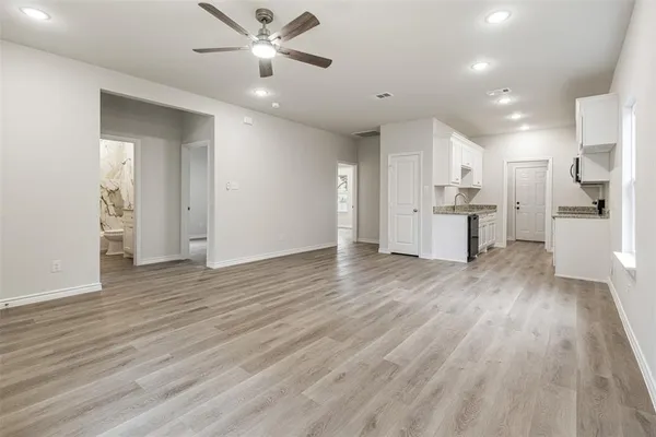 a view of a kitchen with wooden floor and a kitchen