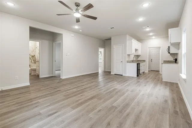 a view of a kitchen with wooden floor and a kitchen