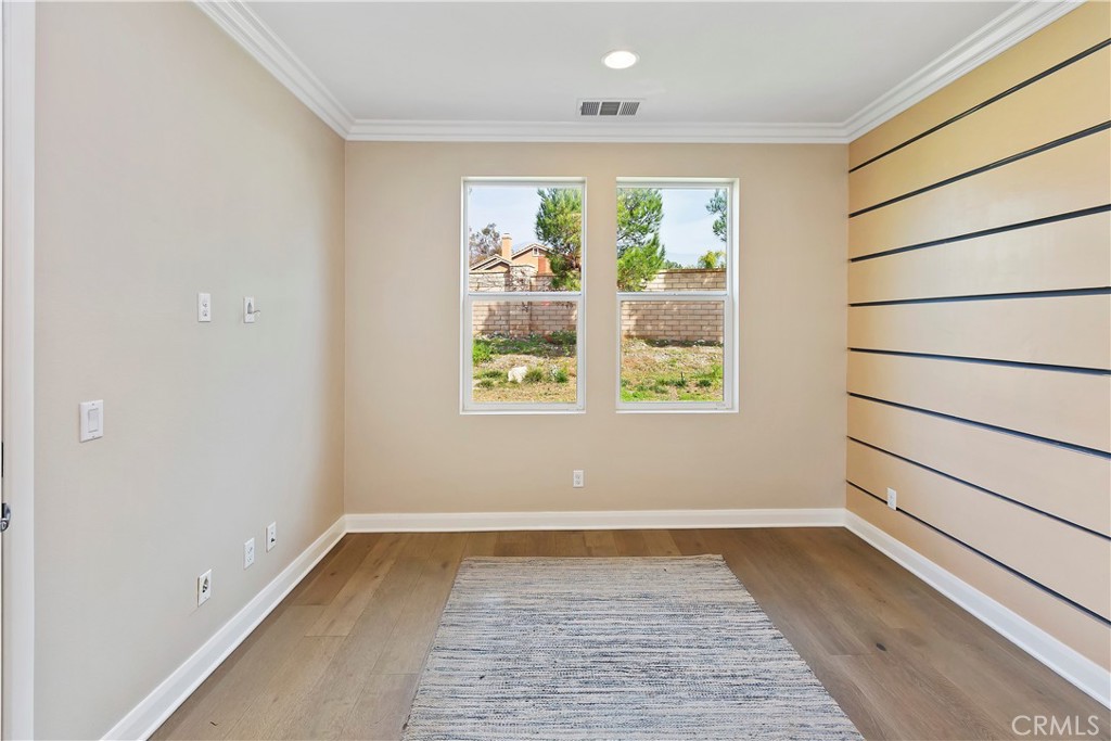 11558 Grimaldi Road Rancho Cucamonga, CA 91701 - Photo 19 of 45 an empty room with wooden floor and windows